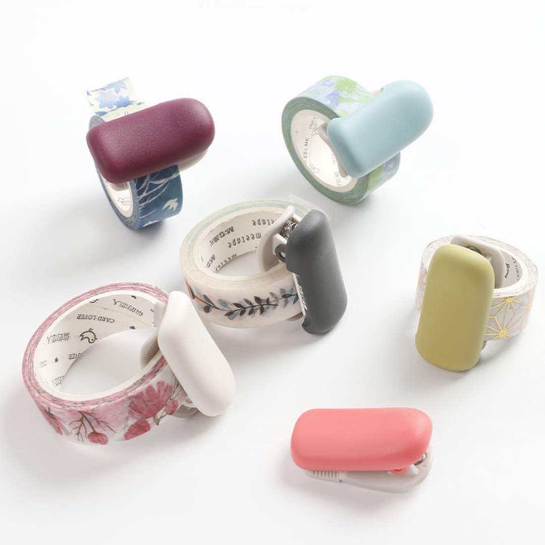 Kokuyo Me Clip-Type Tape Cutter (10-15mm) — Shell Pink — in use on tape roll