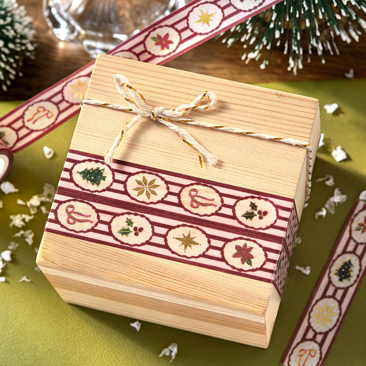 Wooden gift box wrapped with two bands of BGM Holiday Pattern washi tape and tied with gold and cream twine